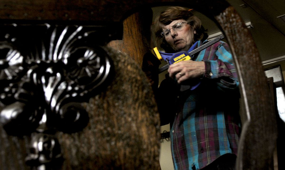 Jackie Malinauskas works on a piece of furniture at The Furniture Doctors in Rathdrum on Jan.27. She started her family’s business 28 years ago.  (KATHY PLONKA Photos / The Spokesman-Review)