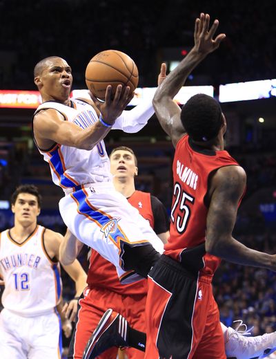 Thunder guard Russell Westbrook shoots over Raptors forward John Salmons. (Associated Press)