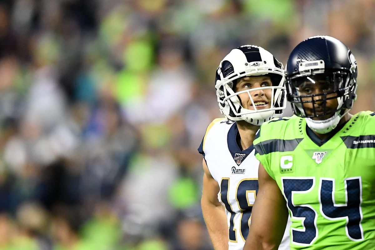 Los Angeles Rams wide receiver Cooper Kupp, left, smiles between plays against the Seattle Seahawks on Oct. 3, 2019, in Seattle.  (TYLER TJOMSLAND)
