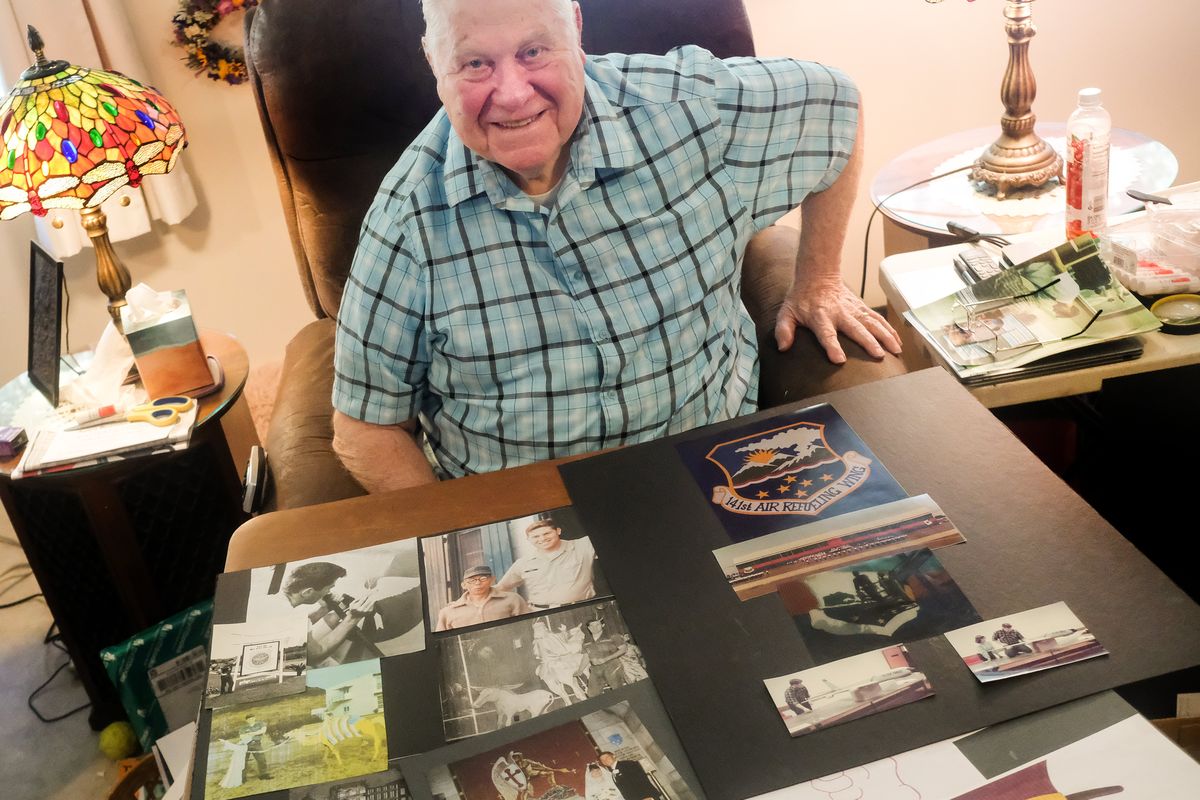 Artist Neal Kimball poses for a photo with a selection of highlights from his work as a commercial artist at his home on Wednesday in Spokane. Kimball has had an impact on the Spokane art scene. From working on the Mr. Yuk campaign to designing the patch for the 141st Air Refueling Wing squadron at Fairchild, to a long teaching career at Mead and Riverside high schools.  (Tyler Tjomsland/The Spokesman-Review)