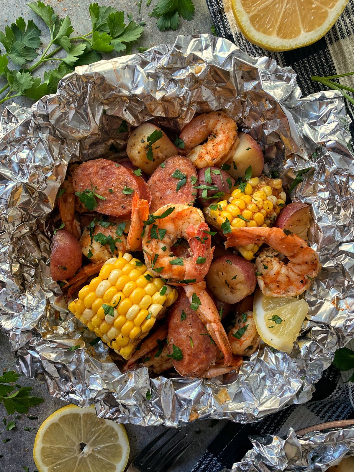 A variety of seafood and vegetables can be used in this recipe for foil packets.  (Audrey Alfaro/For The Spokesman-Review)