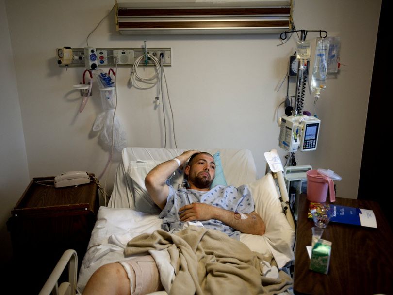 Jesse Hugh Johnson, 24, scratches his head as he lies with a bandaged thigh in a hospital bed on Monday, June 18, 2012, at Providence Sacred Heart Medical Center in Spokane, Wash. Johnson was shot in the leg by a Spokane police officer while armed with what turned out to be a BB gun. Authorities also said he had methamphetamine on him. (Tyler Tjomsland)