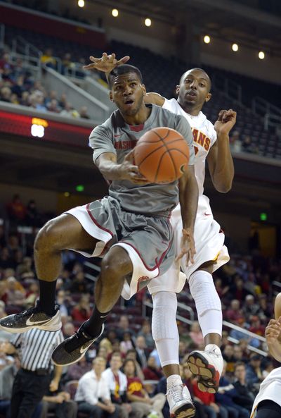 Washington State junior Royce Woolridge (with ball) and USC junior Byron Wesley are both among a growing group of NCAA athletes exercising their right to transfer to another school. (Associated Press)