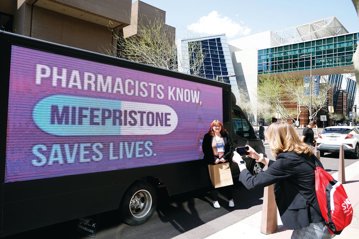 UltraViolet advocates are seen at the American Pharmacists Association Annual Conference at the Phoenix Convention Center on March 25. Advocacy group UltraViolet is urging pharmacists to reaffirm that mifepristone, a medication abortion drug, is safe, effective and essential.  (Chris Coduto)