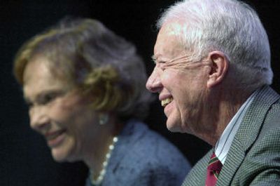 
Former President Jimmy Carter and former First Lady Rosalynn Carter laugh  on Saturday during Carter's three-day University of Georgia symposium. 
 (Associated Press / The Spokesman-Review)