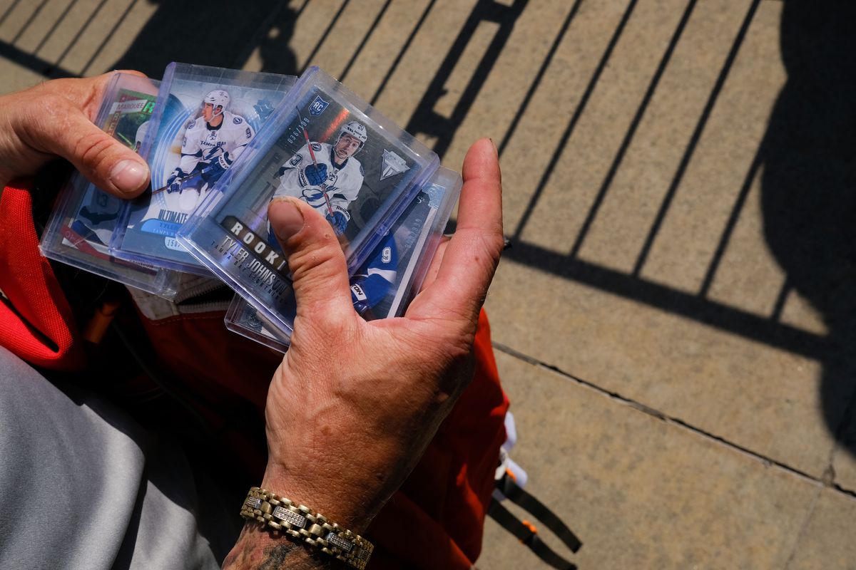 Chiefs fan Roger Ingram holds his collection of Tyler Johnson cards as he awaits Tyler Johnson's return to Spokane with the Stanley Cup, which Johnson won as a member of the Tampa Bay Lightning earlier this year, on Thursday, July 29, 2021, at Spokane Memorial Arena in Spokane, Wash.  (Tyler Tjomsland/The Spokesman-Review)