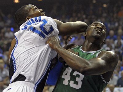 Orlando’s Dwight Howard  and Boston’s Kendrick Perkins battle.  (Associated Press / The Spokesman-Review)