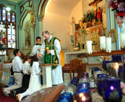 
Mass at St. Michael's is about being reverent and pious, a time of sacrifice.
 (Photos by JOE BARRENTINE / The Spokesman-Review)