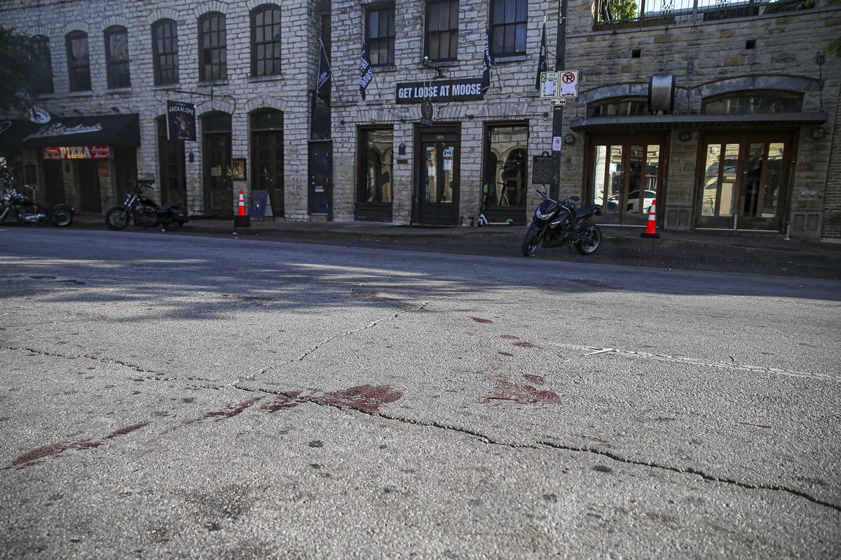Blood stains remain on 6th Street after an early morning shooting on Saturday, June 12, 2021 in downtown Austin, Texas. Authorities say someone opened fire on the busy entertainment district wounding several people before getting away.  (Aaron Martinez)