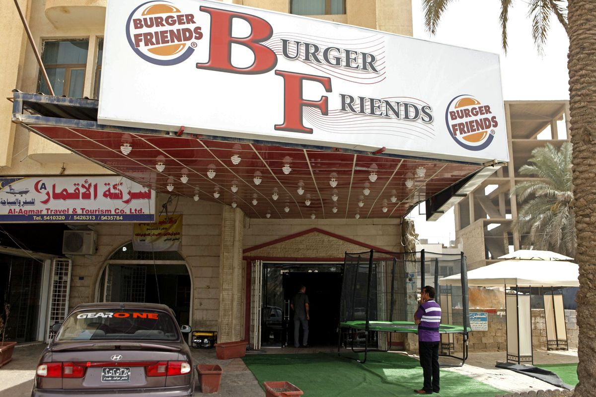 In aThursday, Aug. 23, 2012 photo, A customer stands outside Burger Friends restaurant in Baghdad, Iraq. A wave of new American-style restaurants is spreading across the Iraqi capital, enticing customers hungry for alternatives to traditional offerings like lamb kebabs and fire-roasted carp. (Karim Kadim / Associated Press)