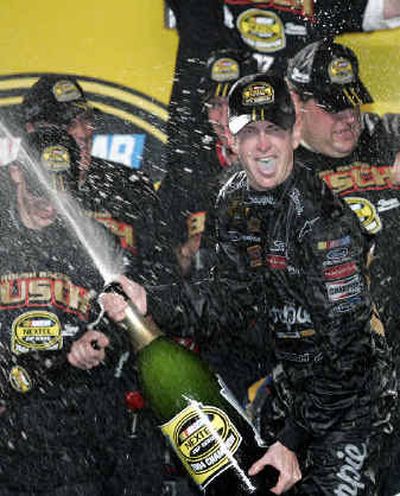 
NASCAR driver Kurt Busch celebrates his 2004 Nextel Cup championship on Sunday.
 (Associated Press / The Spokesman-Review)