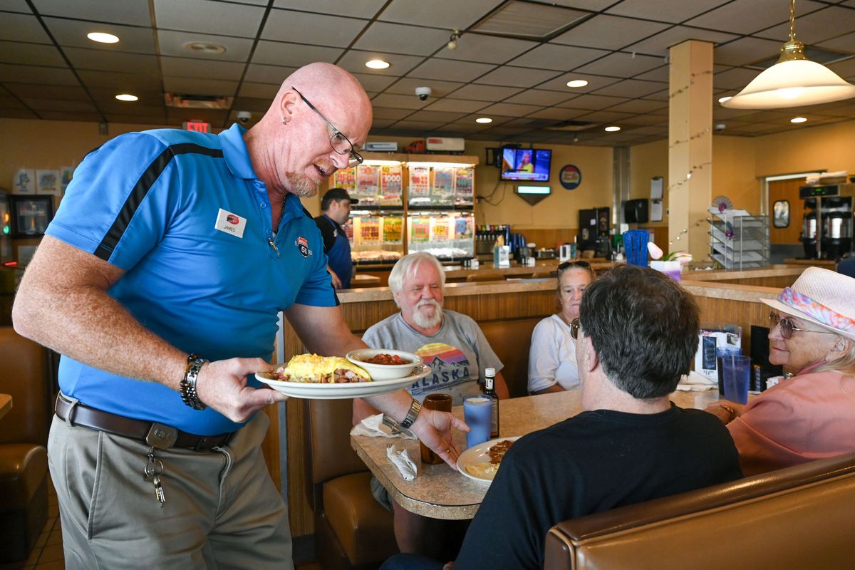 Broadway Diner manager James Nichols serves up breakfast to customers Thursday in Spokane Valley.  (DAN PELLE/THE SPOKESMAN-REVIEW)