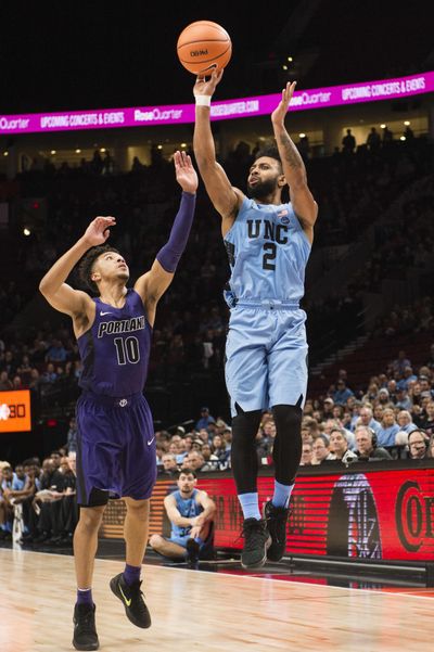 North Carolina guard Joel Berry II, right, shoots a 3-pointer over Portland guard Marcus Shaver Jr., left, during the first half in an NCAA basketball game at the Phil Knight Invitation Tournament, in Portland, Ore., Thursday, Nov. 23, 2017. (Troy Wayrynen / Associated Press)