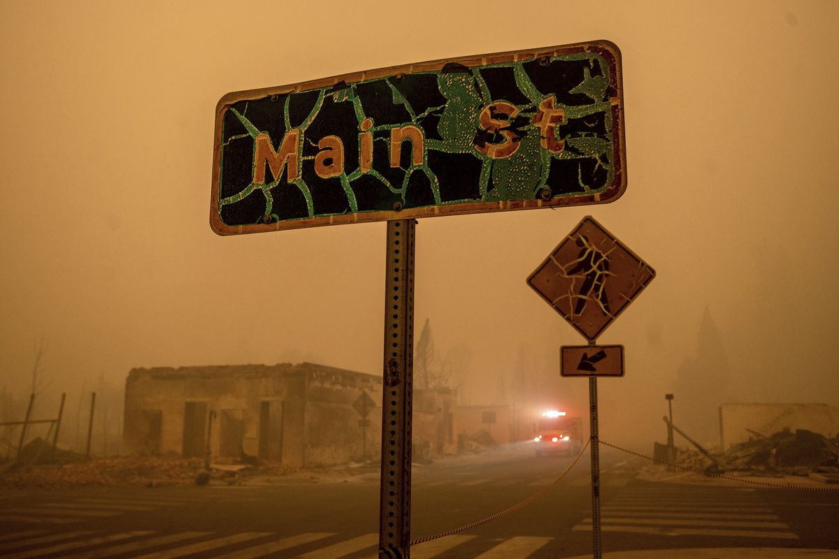 A fire truck drives through central Greenville, which was largely leveled by the Dixie Fire, Friday in Plumas County, Calif.  (Noah Berger)