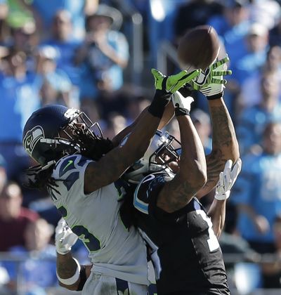 Carolina’s Kelvin Benjamin, right, will test his skills against the likes of Seattle’s Richard Sherman, left, and Earl Thomas, obscured. (Associated Press)
