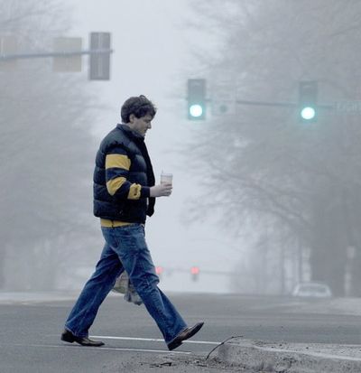 In this Kathy Plonka/SR file photo, a pedestrian walks through the thick fog while acrossing Sherman Ave. in Coeur d'Alene.