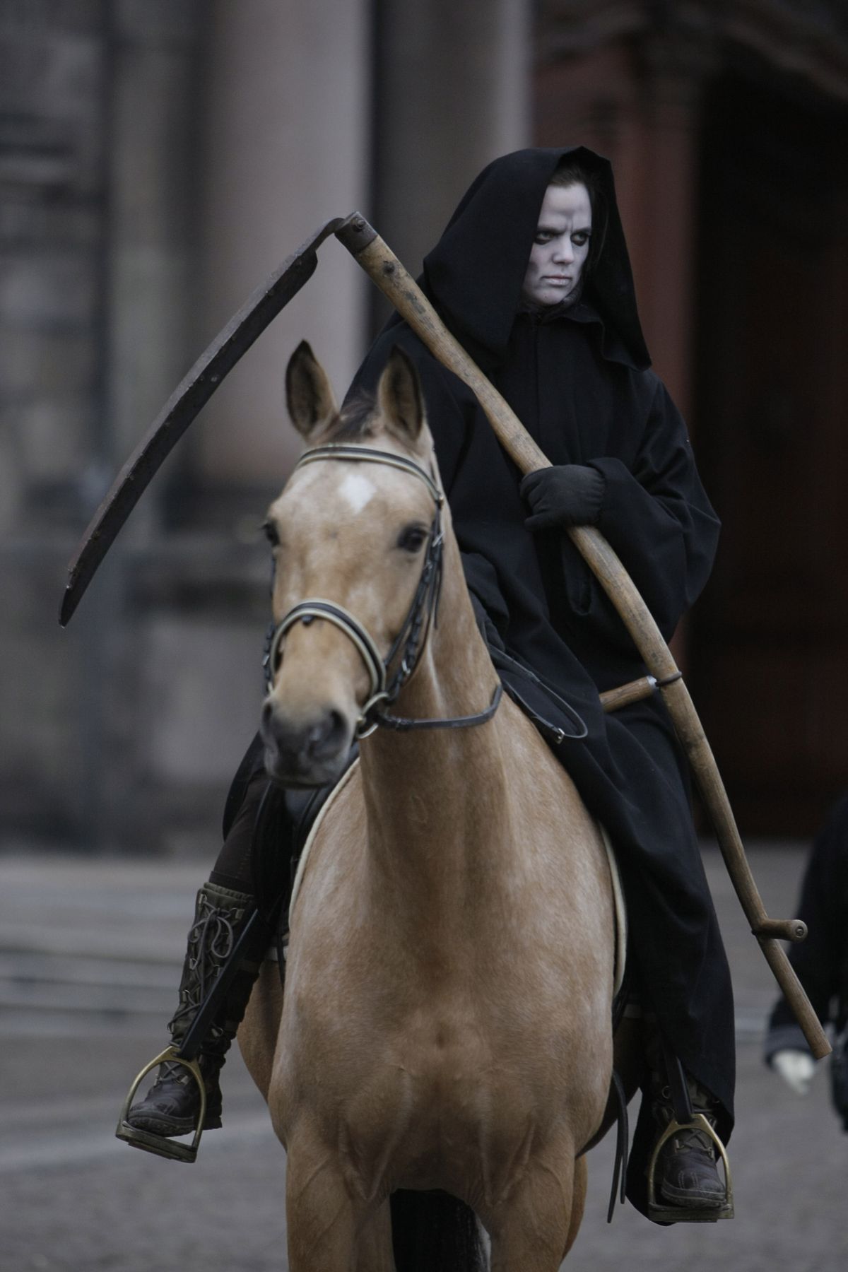 A member of Greenpeace dressed as death on horseback  rides outside parliament during a demonstration in Copenhagen on Monday.