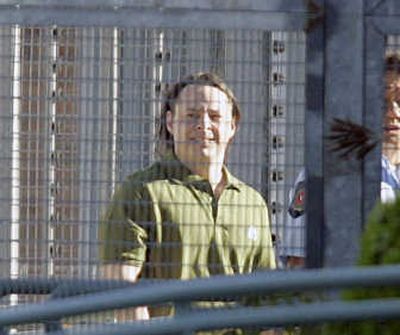 
Former Guantanamo prisoner David Hicks is escorted to a reception area today before leaving Yatala prison in Adelaide. Associated Press
 (Associated Press / The Spokesman-Review)