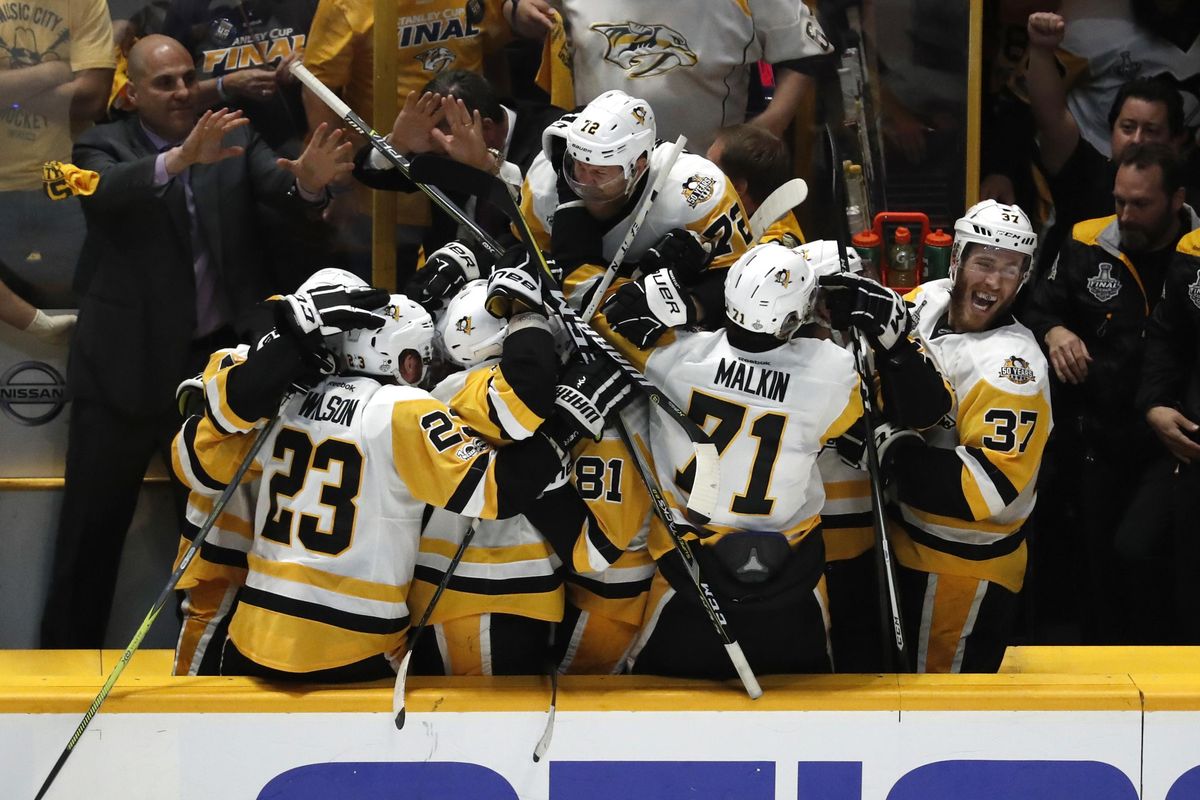 Pittsburgh players react after Carl Hagelin scored an empty-net goal late in the game to clinch the Penguins’ 2-0 win. (Jeff Roberson / Associated Press)