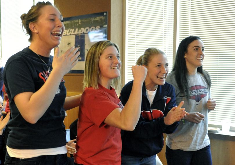 Gonzaga woman's basketball players front row, left to right, Shannon Reader, Carter Schick, Courtney Vandersloot and Meghan Winter react to finding that they will play the University of Iowa in the first round of the NCAA Tournament in the McCarthey Athletic Center in Spokane.  (Colin Mulvany / The Spokesman-Review)