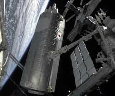 Japan's Kibo lab is removed from the payload bay of the shuttle Discovery on Tuesday for installation on the International Space Station.Associated Press/NASA TV
(Associated Press/NASA TV / The Spokesman-Review)