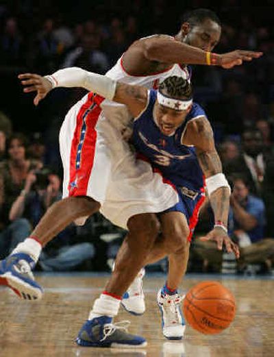 
West's Kobe Bryant, left, collides with Allen Iverson during the fourth quarter. 
 (Associated Press / The Spokesman-Review)