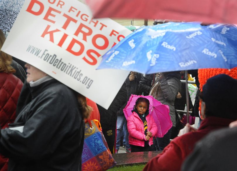 Jordyn Dearing, 5, a Nichols Elementary School student, with her mother who is a teacher there, attends a Detroit Federation of Teachers rally outside Detroit Public Schools offices at the Fisher Building in Detroit, on Monday, May 2, 2016.  The district's state-appointed transition manager Steven Rhodes says 45,628 of approximately 46,000 students were forced to miss classes Monday as 1,562 teachers called in sick. Detroit's schools are expected to be out of cash starting July 1.   (Daniel Mears / The Detroit News)