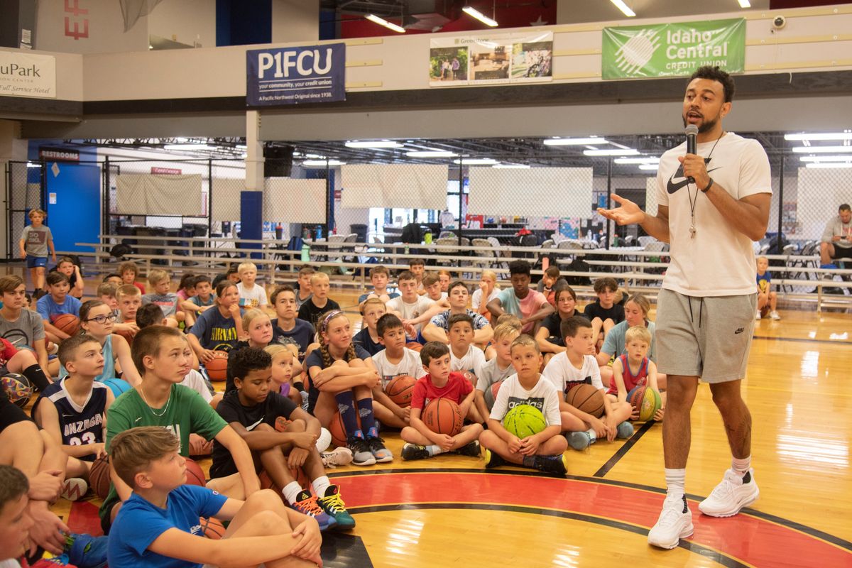 Former Gonzaga Bulldog Nigel Williams-Goss, right, talks to the kids at his basketball camp Monday, Aug. 1, 2022 at The Hub Sports Center in Spokane Valley.  (Jesse Tinsley/The Spokesman-Review)