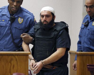 Ahmad Khan Rahimi, center, is led into court Dec. 20, 2016, in Elizabeth, N.J. Rahimi set off small bombs on a New York City street and at a charity race in New Jersey. (Mel Evans / AP)