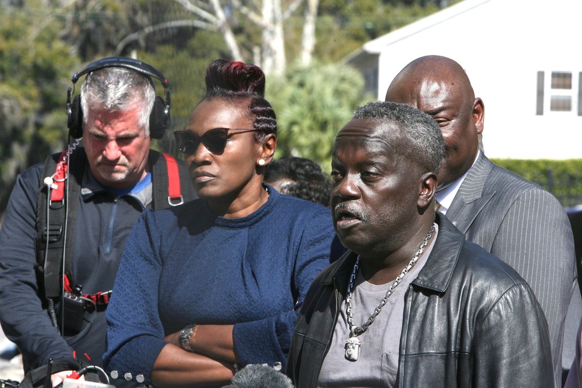 Ahmaud Arbery’s father Marcus Arbery speaks to reporters while Wanda Cooper-Jones stands by his side Tuesday, Feb. 22, 2022 outside the federal courthouse in Brunswick, Ga. The three men convicted of murder in Ahmaud Arbery’s fatal shooting have been found guilty of federal hate crimes. A jury delivered its verdict Tuesday after several hours of deliberations.  (Lewis Levine)