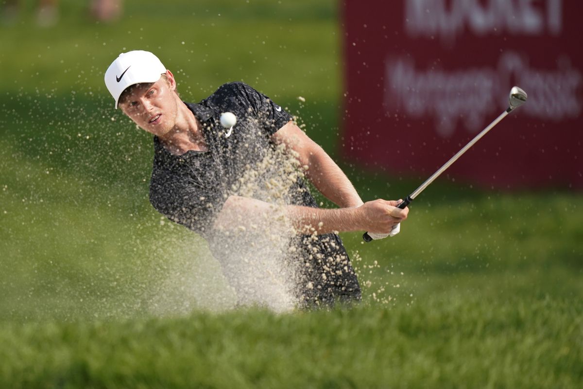 Cam Davis of Australia hits from the sand onto the 17th cup for an eagle during the final round of the Rocket Mortgage Classic golf tournament, Sunday, July 4, 2021, at the Detroit Golf Club in Detroit.  (Carlos Osorio)