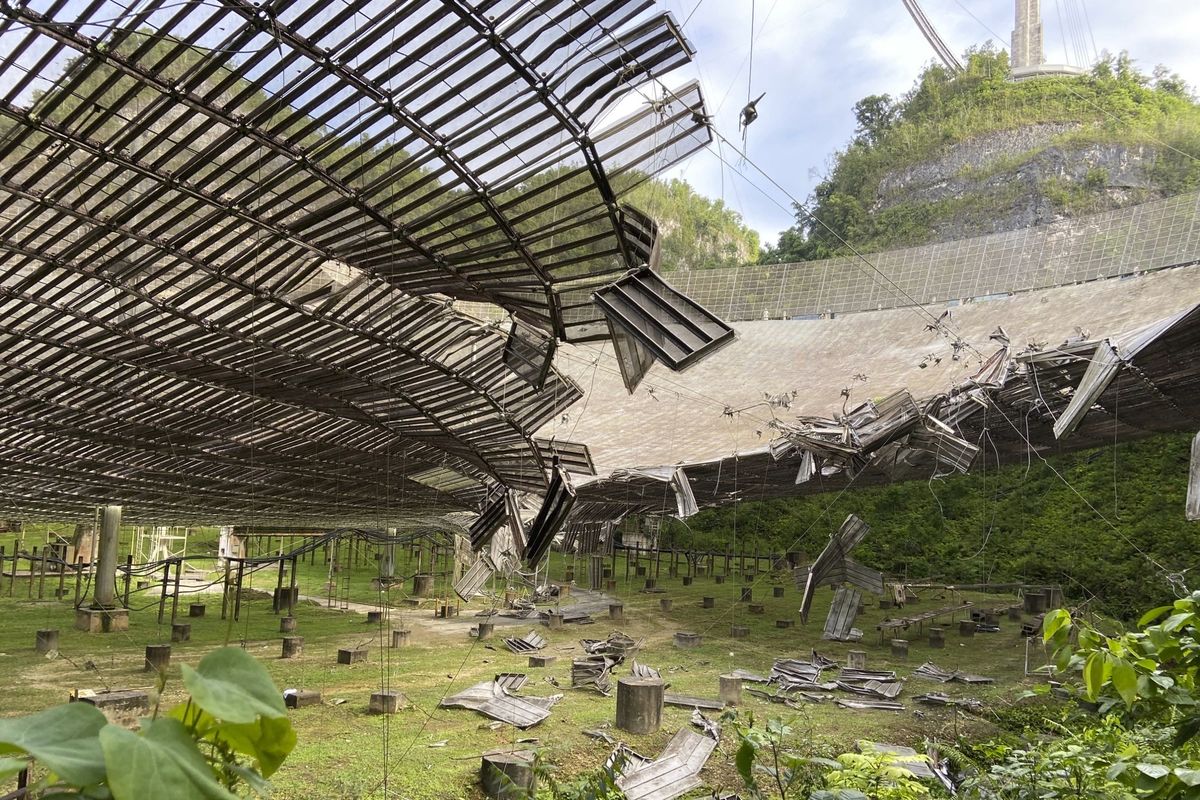 The damage done by a broken cable that supported a metal platform, creating a 100-foot gash to the radio telescope’s reflector dish is shown on Aug. 11 in Arecibo, Puerto Rico.  (HONS)