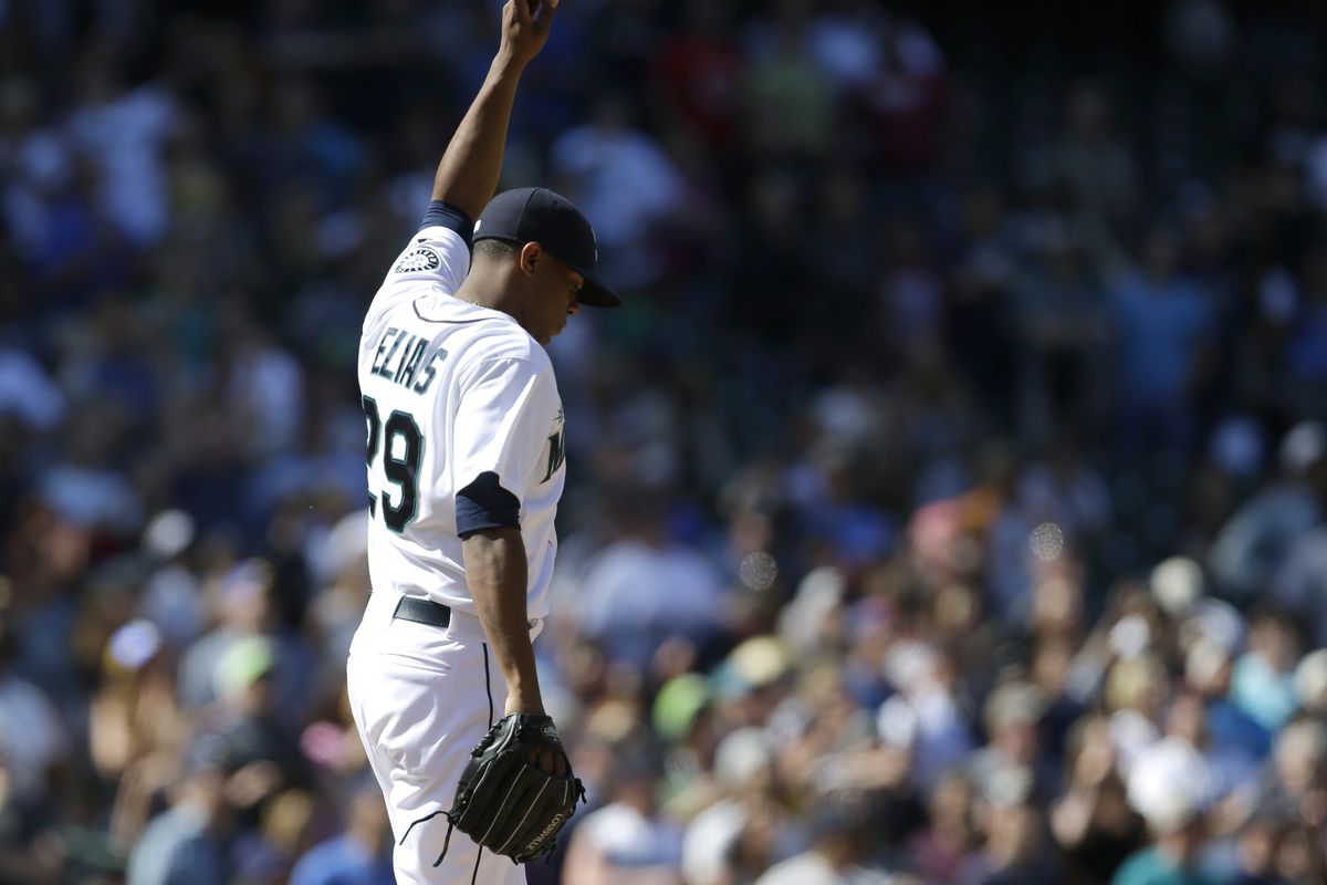Mariners rookie starting pitcher Roenis Elias points skyward after throwing his first major league complete game and shutout. (Associated Press)