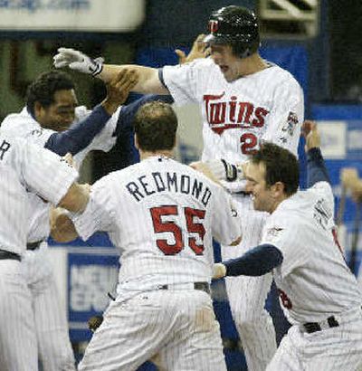 
Lew Ford, top, is swarmed by jubilant Twins.
 (Associated Press / The Spokesman-Review)