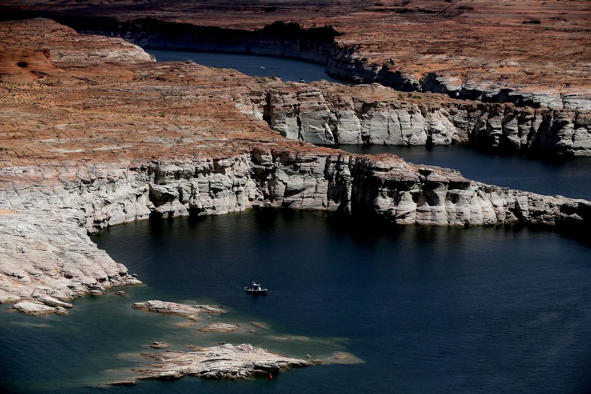 A boat is anchored in one of the many coves on Lake Powell in May 2021.  (Tribune News Service)