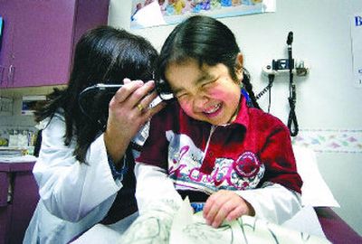 
Douglas Birdtail, 4, giggles as nurse practitioner Vinetta MacPherson checks his ears at NATIVE Health of Spokane on Thursday. 
 (Christopher Anderson / The Spokesman-Review)