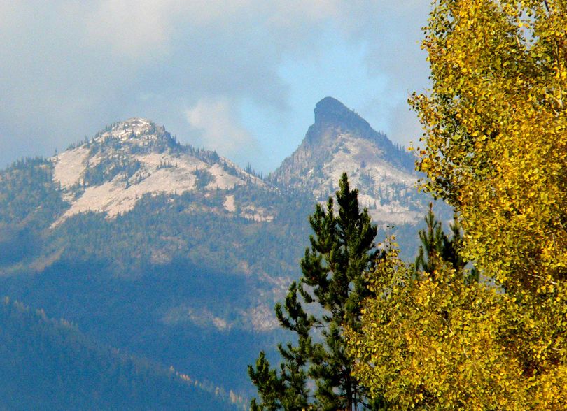 FILE - Scenic vistas of the Scotchman Peaks wilderness study area are hard to find. Middle Mountain and Sawtooth Mountain appear through a break in the trees around the small town of Heron. (Rob Chaney / Courtesy)