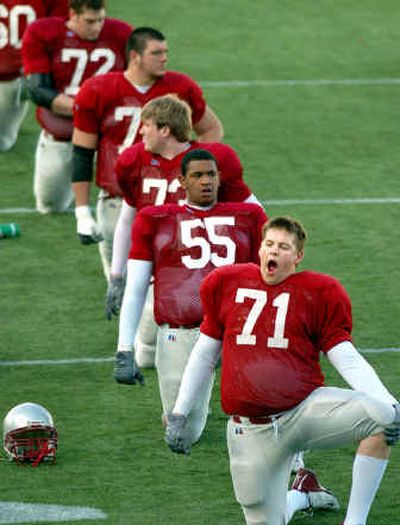 
Lineman Spencer Hollison yawns as he and the rest of the Washington State University Cougars stretch before practice Wednesday at Rogers Field. 
 (Joe Barrentine / The Spokesman-Review)