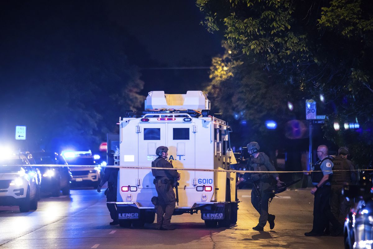 Chicago police and SWAT officers investigate on the 4400 block of West Walton Street where an alleged gunman barricaded himself in a building after one man was killed and three other people were wounded Sunday night in a shooting in West Humboldt Park on the west side of town.  (Ashlee Rezin)