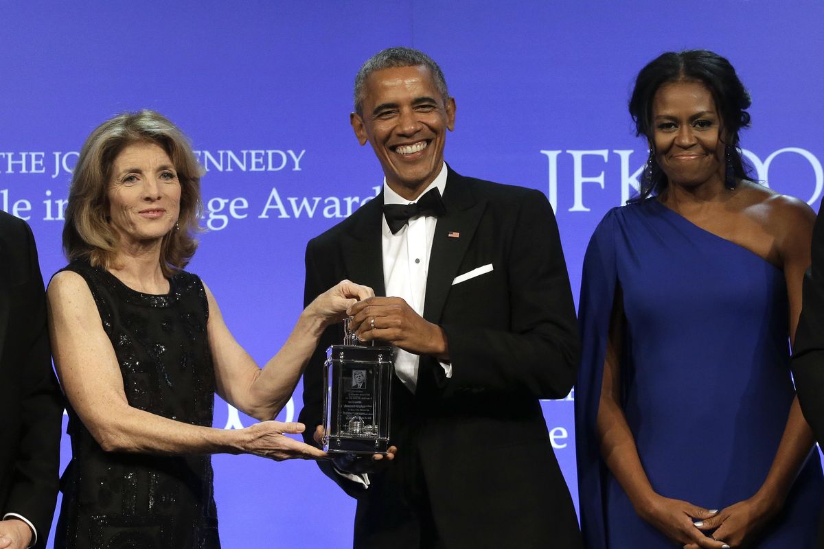 Former President Barack Obama is presented with the 2017 Profile in Courage award Sunday by former  Caroline Kennedy, left, as former first lady Michelle Obama looks on. (Steven Senne / Associated Press)