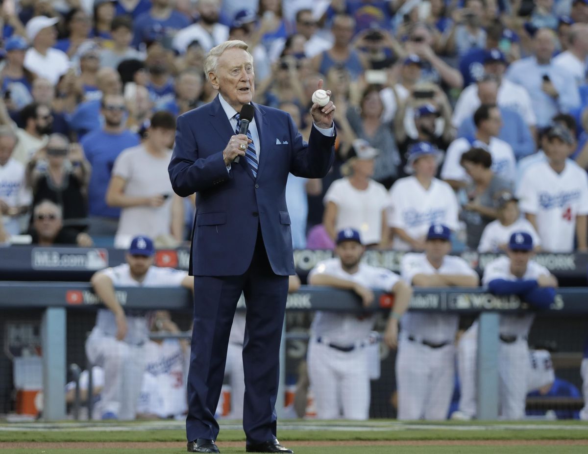Vin Scully helps throw out the ceremonial first pitch before Game 2 of baseball