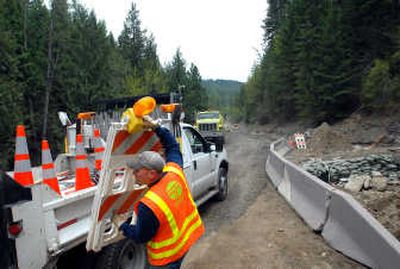 
Keith Piccioni, of the Washington Department of Transportation, picks up barricades after the newly repaired section of state Route 206  is reopened just outside  Mount Spokane State Park on Thursday. Snowmelt in Deadman Creek washed out the road May 18, cutting off the park. 
 (Jesse Tinsley / The Spokesman-Review)