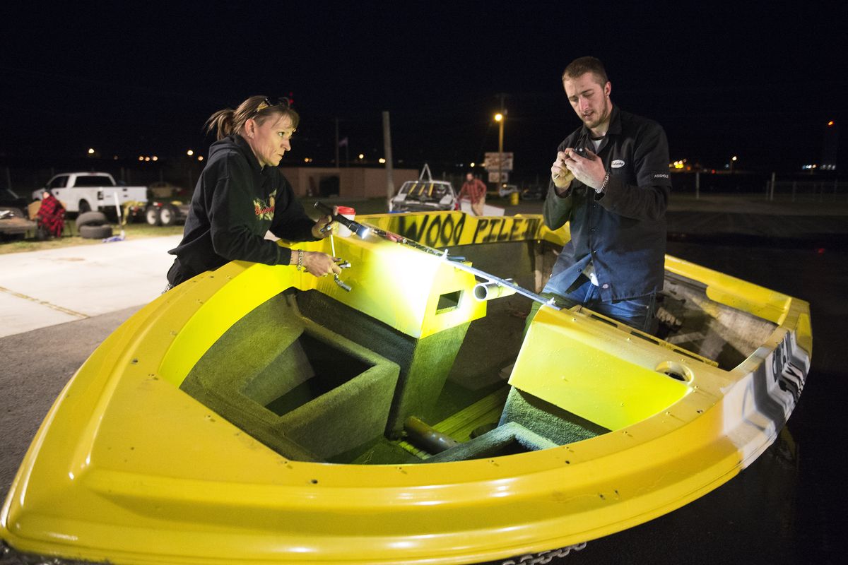 Race crew members Shannon Bowman and Jason DeFord prepare the The Crazy Taxi boat before the full-contact boat race at Stateline Speedway.