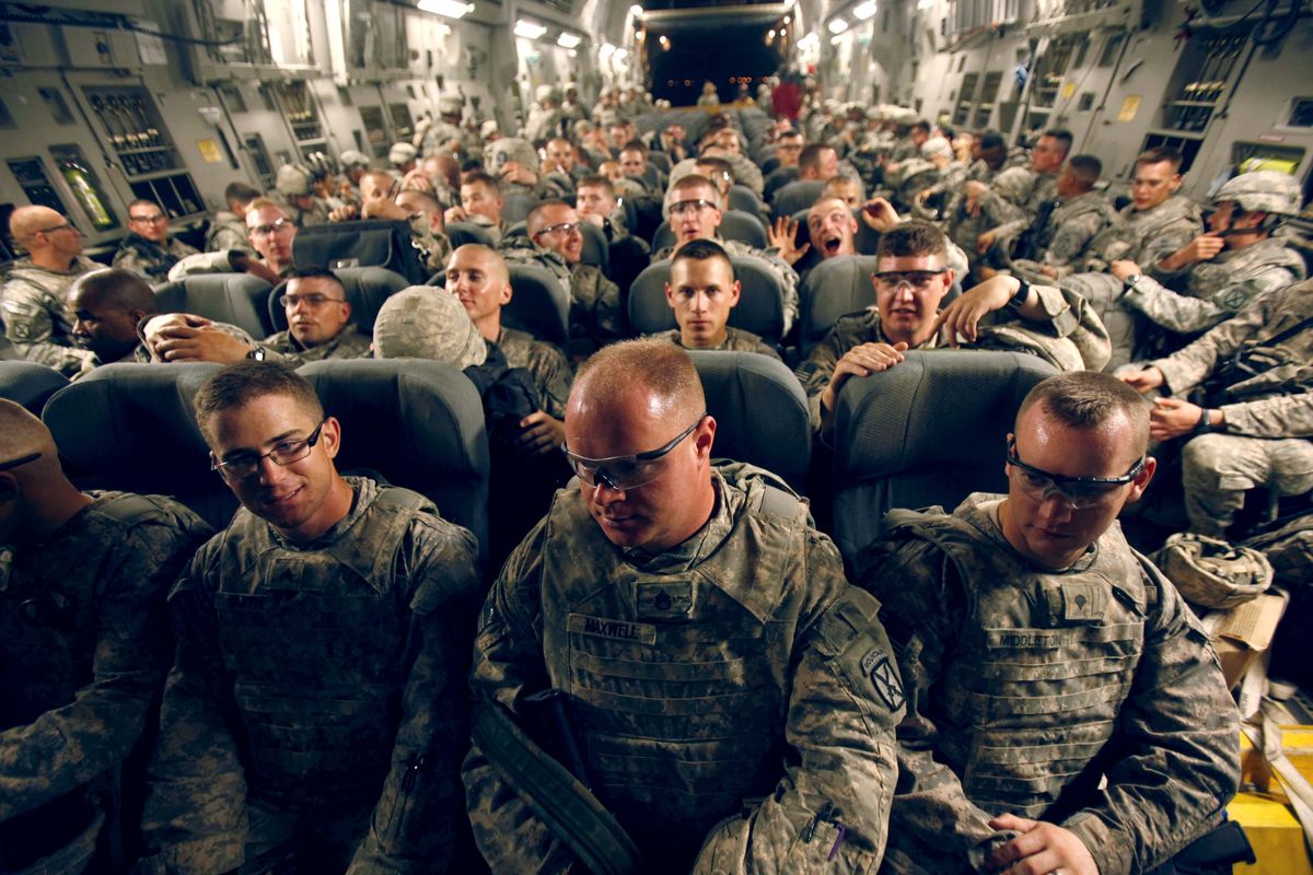 U.S. Army soldiers leave Iraq on a C-17 transport aircraft Tuesday after a nine month tour of duty. (Associated Press)