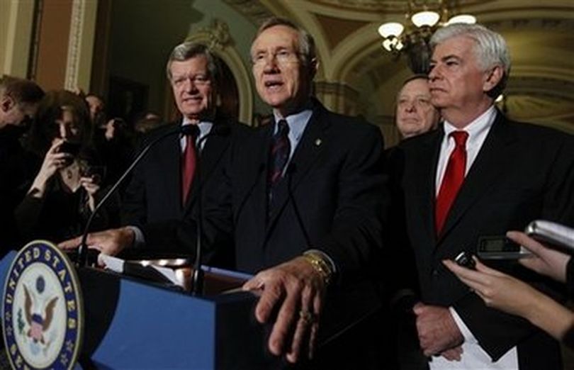 Senate Majority Leader Harry Reid of Nev., center, answers questions outside of the Senate chambers on Capitol Hill in Washington, Thursday, Dec. 24, 2009, after the Senate passed the health care reform bill. From left are, Senate Finance Finance Committee Chairman Sen. Max Baucus, D-Mont., Reid, Senate Majority Whip Richard Durbin of Ill., and Senate Banking Committee Chairman Sen. Christopher Dodd, D-Conn..
(AP Photo/Mannul Balce Ceneta)
Photo Tools
 (Mannul Ceneta / Associated Press)