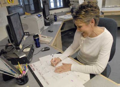 
Francie Neal writes phone messages for teachers at Mountain View Middle School.  
 (J. BART RAYNIAK / The Spokesman-Review)
