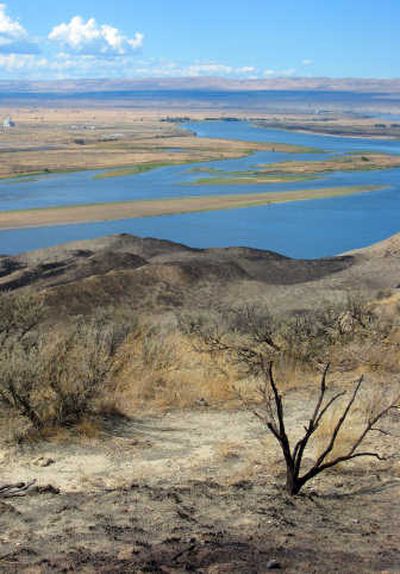 
Singed sagebrush and scorched ground are shown on a bluff overlooking the Columbia River inside the Hanford Reach National Monument on Tuesday. Associated Press
 (Associated Press / The Spokesman-Review)