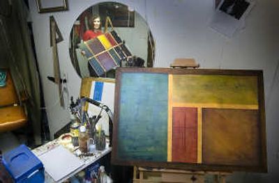 
Artist Dawn Hatchett holds one of her creations in the basement studio of her home. Hatchett works in ink and oil.
 (Photos by CHRISTOPHER ANDERSON / The Spokesman-Review)