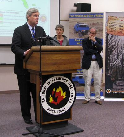 Secretary of Agriculture Tom Vilsack speaks at the National Interagency Fire Center in Boise; at right are Secretary of the Interior Sally Jewell and Idaho Sen. Jim Risch (Betsy Russell)