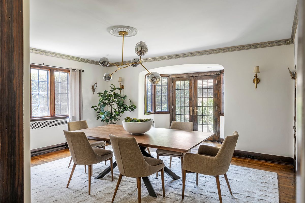 A walnut wood table adds a feeling of warmth in a dining space with similar wood details and elements. (Handout/TNS)  (Handout)